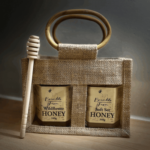 Gift bag containing two jars of Kent honey with wooden honey drizzler